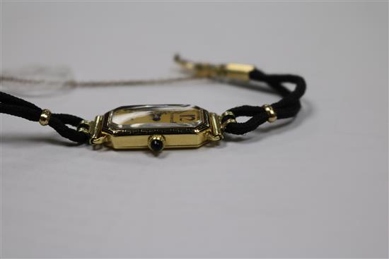 A ladys 18ct gold Longines manual wind wrist watch retailed by Tiffany & Co, on fabric strap.